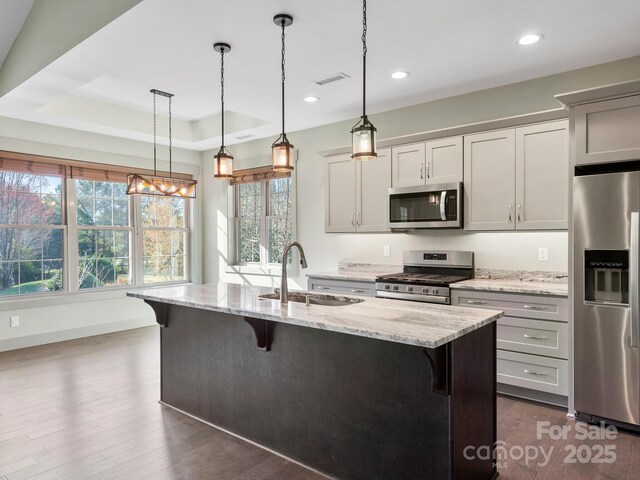 0 Welding Way Unit 128, Hendersonville, NC 28792 - kitchen featuring appliances with stainless steel finishes, a sink, a breakfast bar, plenty of natural light, and recessed lighting