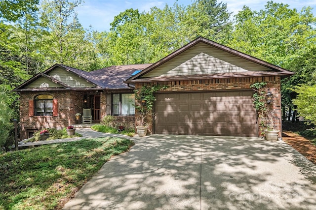 single story home with an attached garage, concrete driveway, and brick siding