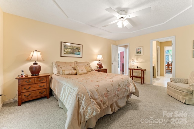 bedroom featuring light colored carpet, baseboards, and a ceiling fan