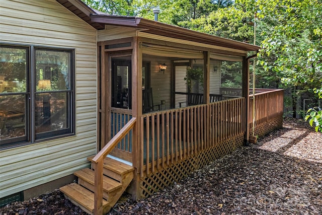 wooden deck featuring a sunroom