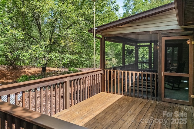 wooden deck with a sunroom