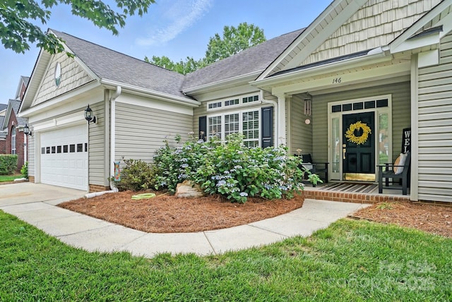 146 Burtons Barn Rd, Mooresville, NC 28115 - property entrance with a porch, an attached garage, a shingled roof, and driveway