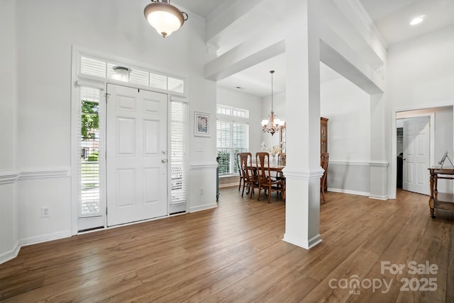146 Burtons Barn Rd, Mooresville, NC 28115 - entryway with wood finished floors, a chandelier, baseboards, and a towering ceiling