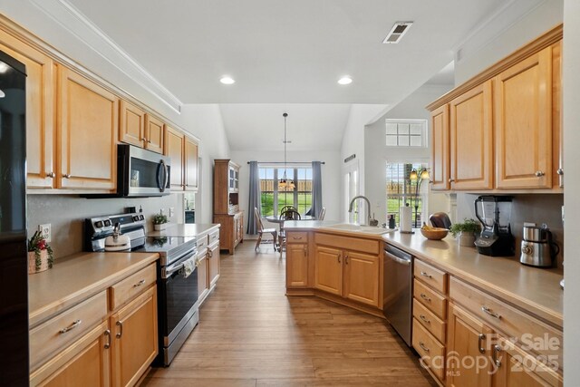 146 Burtons Barn Rd, Mooresville, NC 28115 - kitchen with appliances with stainless steel finishes, a sink, a peninsula, light wood finished floors, and light countertops