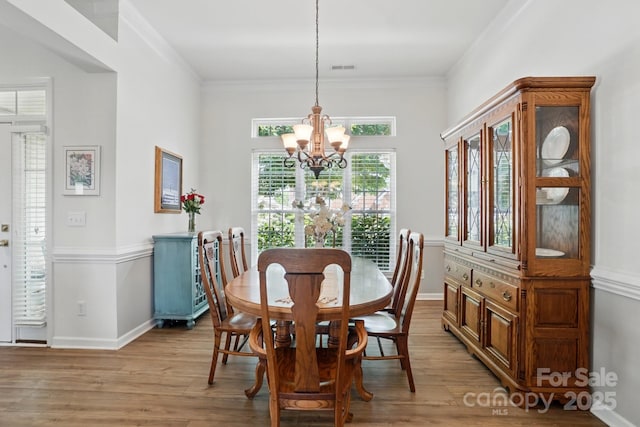 146 Burtons Barn Rd, Mooresville, NC 28115 - dining room with a chandelier, light wood-style flooring, baseboards, and crown molding