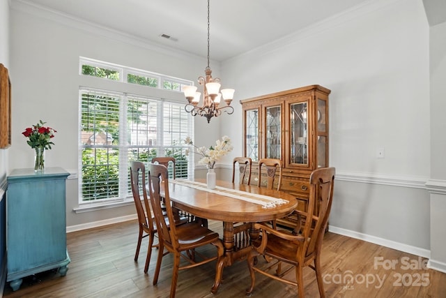 146 Burtons Barn Rd, Mooresville, NC 28115 - dining space with a chandelier, healthy amount of natural light, wood finished floors, and ornamental molding