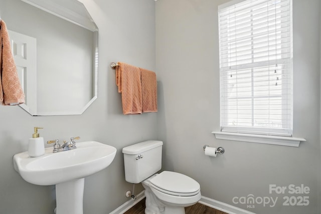 146 Burtons Barn Rd, Mooresville, NC 28115 - half bathroom featuring baseboards, toilet, wood finished floors, and a sink