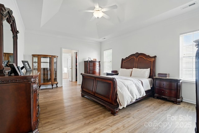 146 Burtons Barn Rd, Mooresville, NC 28115 - bedroom featuring crown molding, light wood finished floors, a tray ceiling, and a ceiling fan