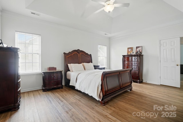 146 Burtons Barn Rd, Mooresville, NC 28115 - bedroom featuring light wood-type flooring, ornamental molding, a raised ceiling, baseboards, and ceiling fan