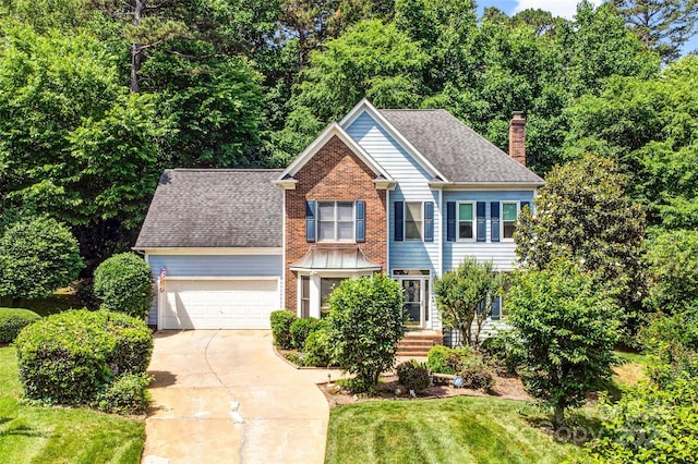 5238 Downing Creek Dr, Charlotte, NC 28269 - view of front facade featuring a chimney, driveway, an attached garage, brick siding, and a front lawn