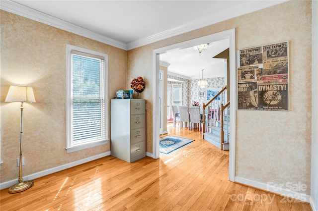 5238 Downing Creek Dr, Charlotte, NC 28269 - interior space with a chandelier, light wood-type flooring, wallpapered walls, healthy amount of natural light, and ornamental molding
