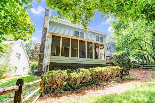 5238 Downing Creek Dr, Charlotte, NC 28269 - view of front of house featuring fence, a sunroom, and a chimney