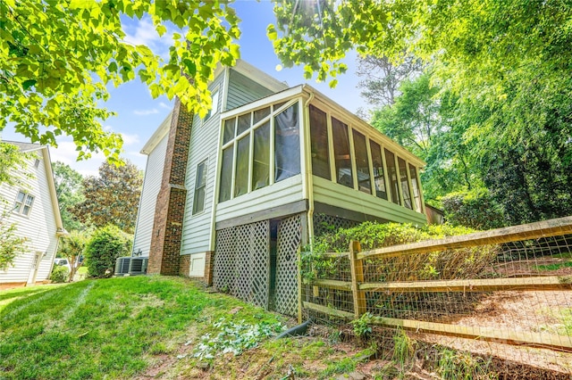 5238 Downing Creek Dr, Charlotte, NC 28269 - view of property exterior with a sunroom and central AC