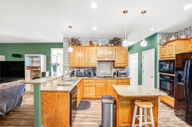 5238 Downing Creek Dr, Charlotte, NC 28269 - kitchen featuring black appliances, a sink, a peninsula, light wood finished floors, and recessed lighting