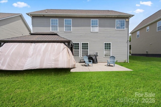 back of property featuring a gazebo, a patio area, and a yard