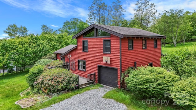 1925 Green Hill Rd, Blowing Rock, NC 28605 - view of home's exterior with driveway, an attached garage, view of scattered trees, and a shingled roof