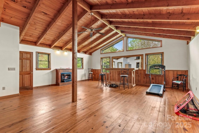 1925 Green Hill Rd, Blowing Rock, NC 28605 - living room with hardwood / wood-style floors, wooden ceiling, wainscoting, a glass covered fireplace, and plenty of natural light