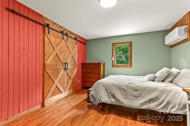1925 Green Hill Rd, Blowing Rock, NC 28605 - bedroom featuring a wall unit AC, wood finished floors, and a barn door