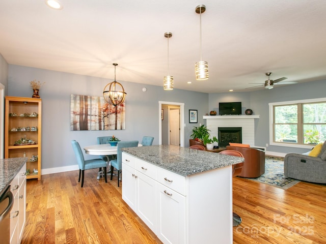 5 S Pine Dr, Weaverville, NC 28787 - kitchen with ceiling fan, light wood-style flooring, white cabinetry, a kitchen island, and stone countertops