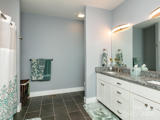 5 S Pine Dr, Weaverville, NC 28787 - bathroom featuring double vanity, baseboards, and toilet