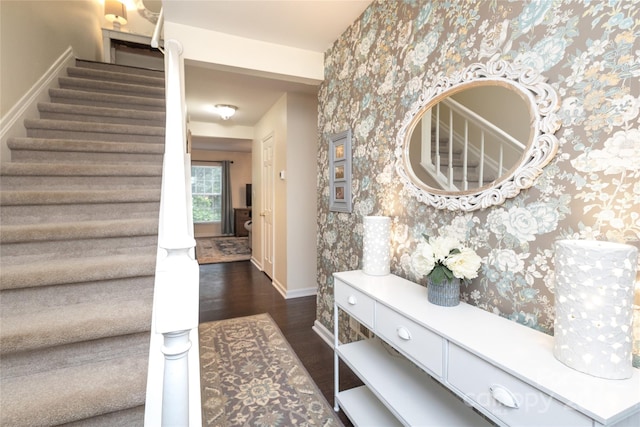 8306 Knights Bridge Rd, Charlotte, NC 28210 - entryway with wallpapered walls, stairs, baseboards, and dark wood-style flooring