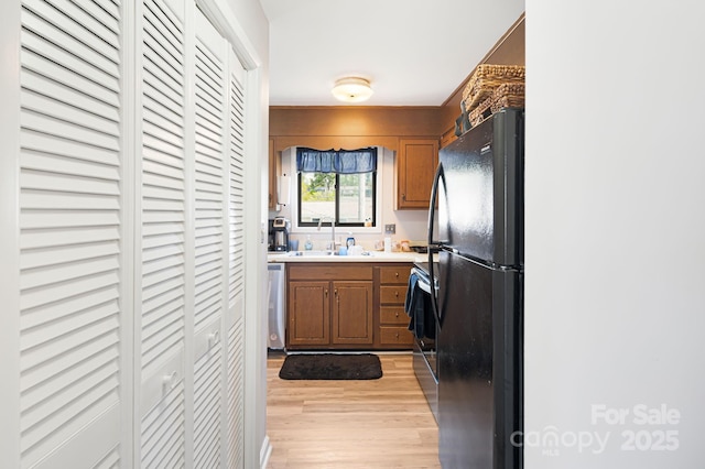 319 Greenville Hwy Unit 302, Brevard, NC 28712 - kitchen featuring freestanding refrigerator, a sink, dishwasher, light wood-type flooring, and light countertops