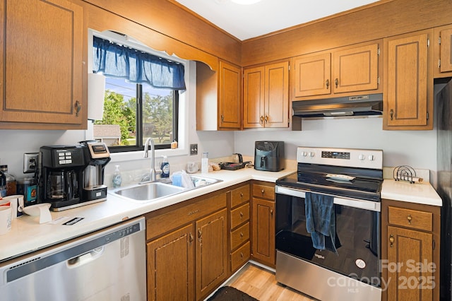 319 Greenville Hwy Unit 302, Brevard, NC 28712 - kitchen featuring stainless steel appliances, under cabinet range hood, a sink, and light countertops