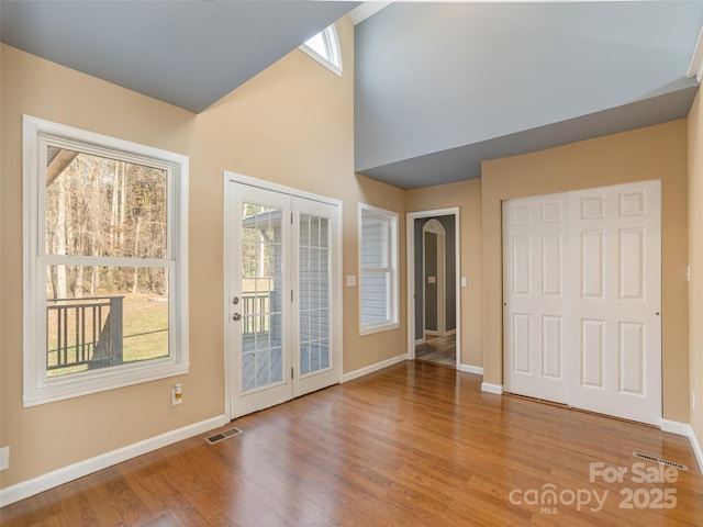 530 Stoney Mountain Rd, Hendersonville, NC 28791 - interior space with baseboards, wood finished floors, a towering ceiling, and french doors