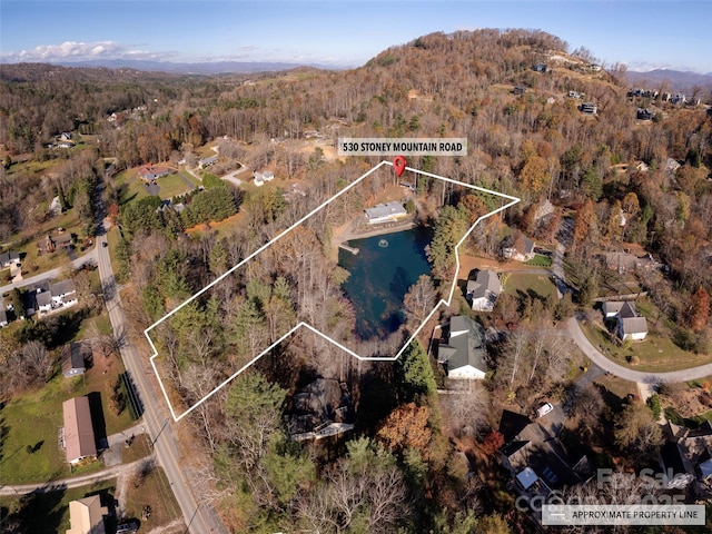 530 Stoney Mountain Rd, Hendersonville, NC 28791 - aerial view of property and surrounding area featuring a heavily wooded area, property boundaries highlighted, and a mountainous background