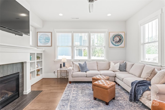 5210 Kelly St, Charlotte, NC 28205 - living room featuring plenty of natural light, wood finished floors, a tile fireplace, a ceiling fan, and recessed lighting