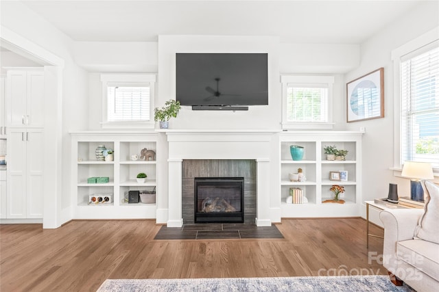5210 Kelly St, Charlotte, NC 28205 - unfurnished living room featuring wood finished floors, a fireplace with flush hearth, and healthy amount of natural light