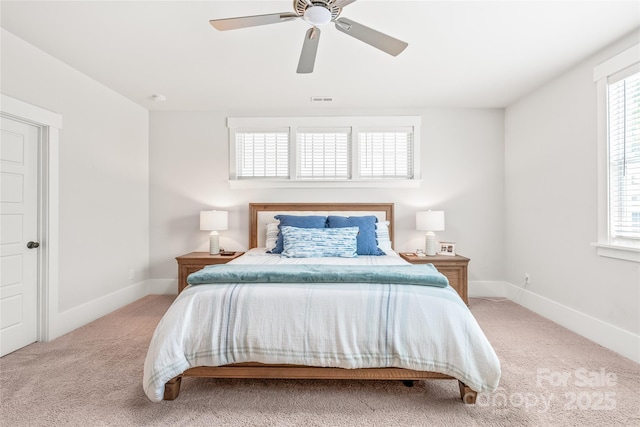 5210 Kelly St, Charlotte, NC 28205 - bedroom featuring light colored carpet, multiple windows, baseboards, and a ceiling fan