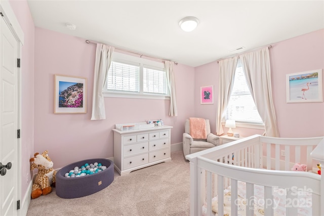 5210 Kelly St, Charlotte, NC 28205 - carpeted bedroom featuring a nursery area and multiple windows