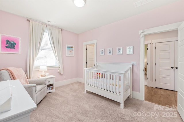 5210 Kelly St, Charlotte, NC 28205 - bedroom with carpet floors, baseboards, and a nursery area