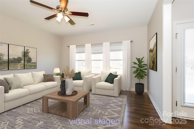living room with wood finished floors, plenty of natural light, ceiling fan, and baseboards
