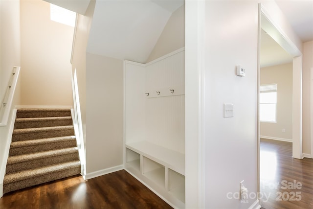 mudroom featuring dark wood finished floors and vaulted ceiling