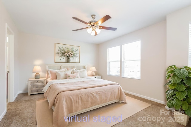 bedroom featuring light carpet, baseboards, and ceiling fan
