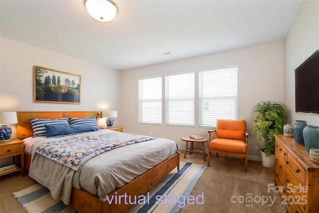 bedroom featuring light colored carpet and baseboards