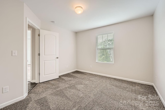 2327 Glenway Trail Ct, Pineville, NC 28134 - spare room featuring dark colored carpet, baseboards, and a smoke detector