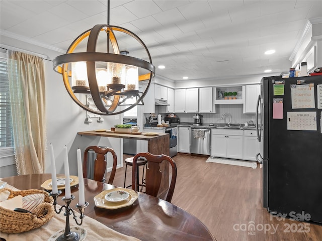1544 US-221A Hwy, Mooresboro, NC 28114 - dining space with ornamental molding, dark wood-style flooring, a chandelier, and recessed lighting