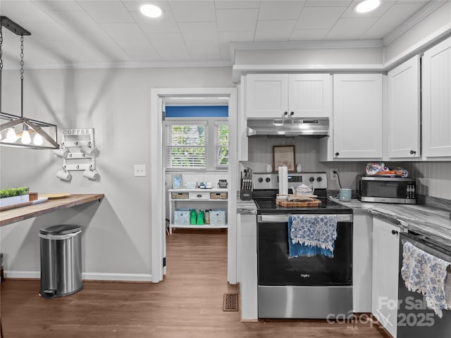 1544 US-221A Hwy, Mooresboro, NC 28114 - kitchen featuring stainless steel appliances, under cabinet range hood, crown molding, wood finished floors, and white cabinetry