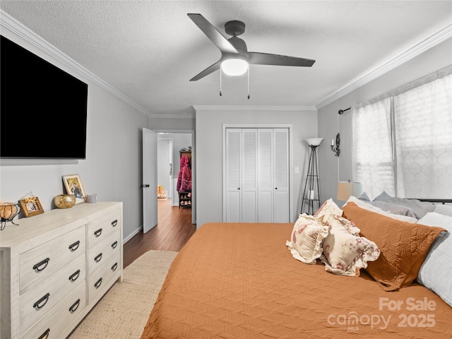 1544 US-221A Hwy, Mooresboro, NC 28114 - bedroom with wood finished floors, crown molding, a closet, ceiling fan, and a textured ceiling