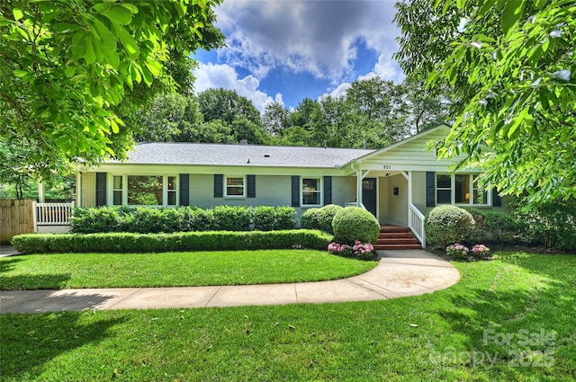 ranch-style house featuring brick siding and a porch