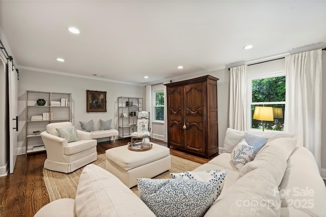 living room with healthy amount of natural light, ornamental molding, wood finished floors, recessed lighting, and a barn door