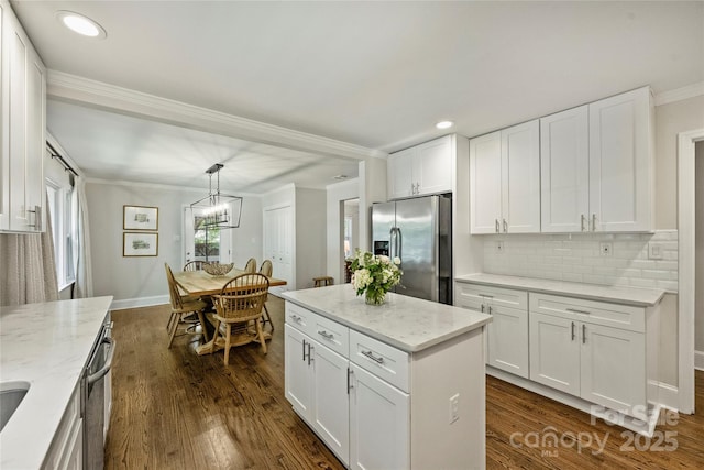 kitchen with stainless steel appliances, dark wood finished floors, white cabinetry, backsplash, and crown molding
