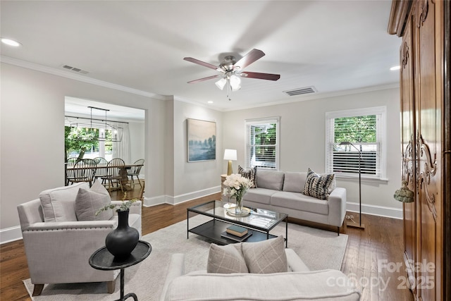 living area with plenty of natural light, baseboards, ceiling fan, ornamental molding, and recessed lighting