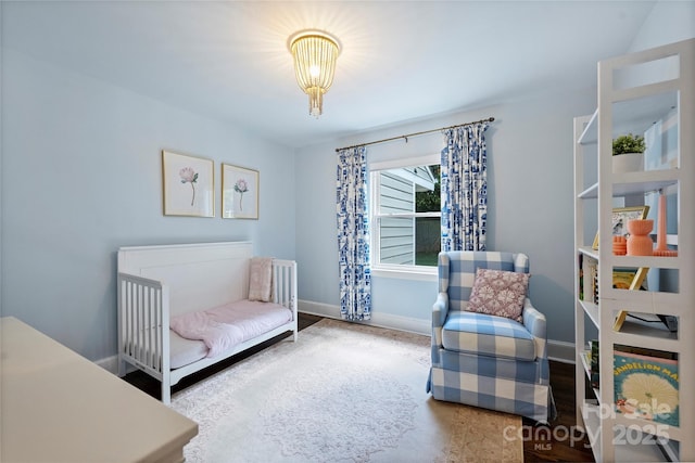 bedroom with baseboards and wood finished floors