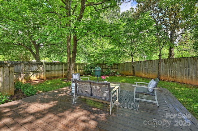 deck featuring a fenced backyard and an outdoor living space