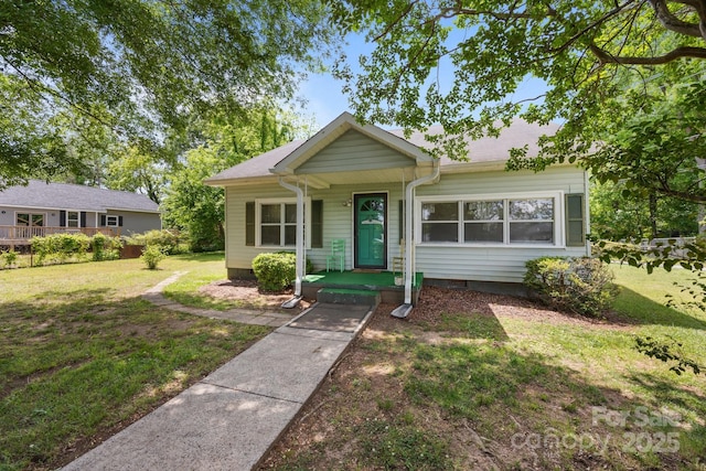view of front of home with a front yard, crawl space, and covered porch