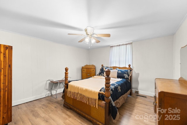 bedroom featuring wood finished floors, ceiling fan, and baseboards